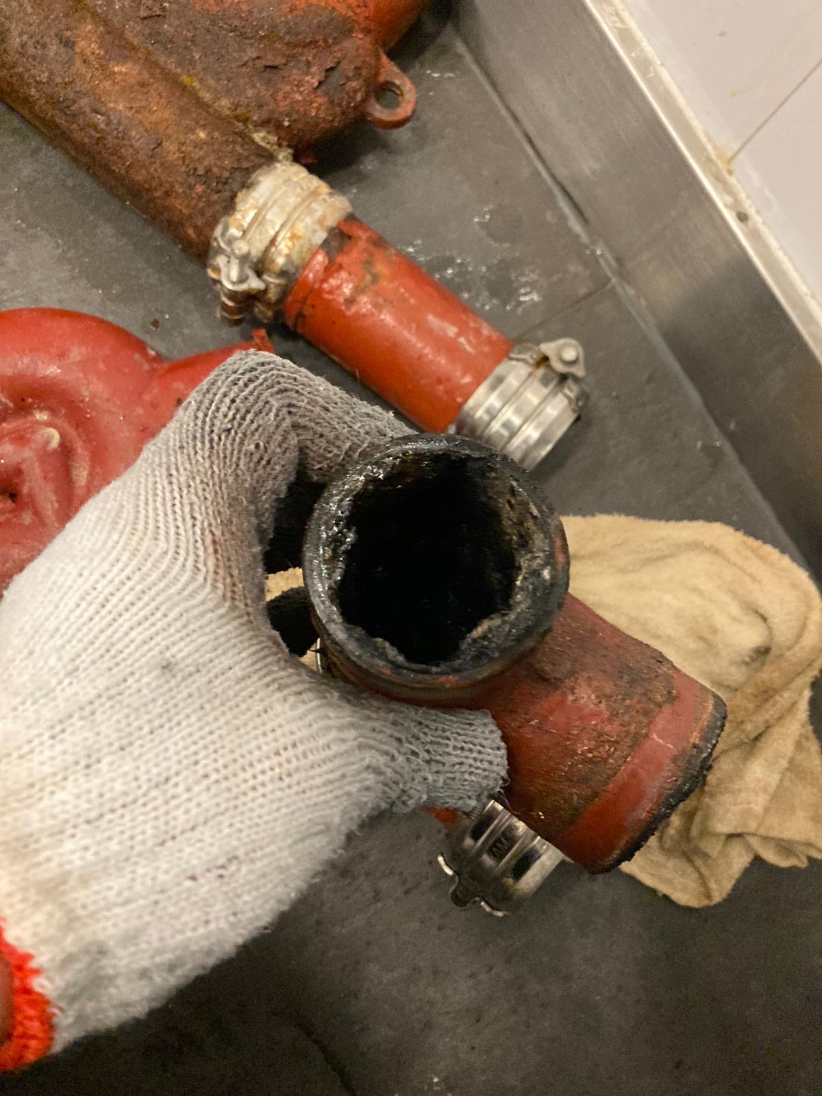 DrainFix HK 渠管內油脂結痂 — 切開鑄鐵管段展示硬化沉積